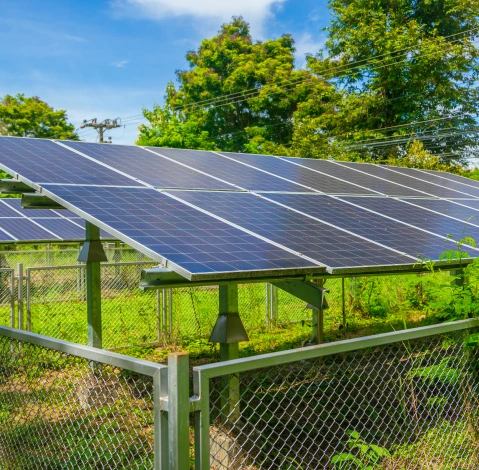 Ground-mounted solar panel array providing sustainable energy and backup power for residential or commercial properties